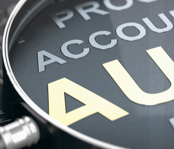 magnifying glass focused on the word Audit 